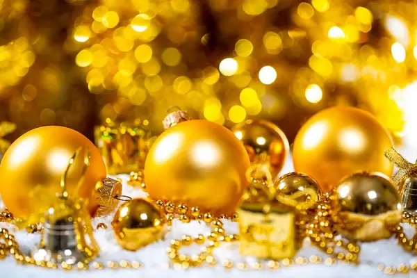 Christmas composition with Golden Christmas toys in the snow