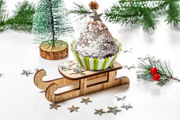 Christmas cupcake on a sled and a tree on a white background (Flip 2019)