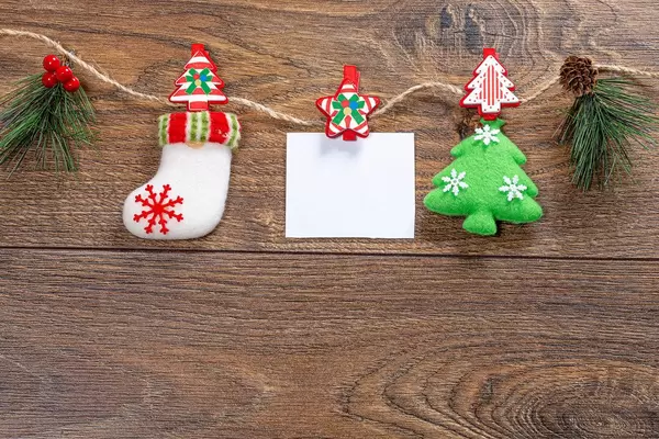 Christmas decor with thread on brown wooden background with free space (Flip 2019)