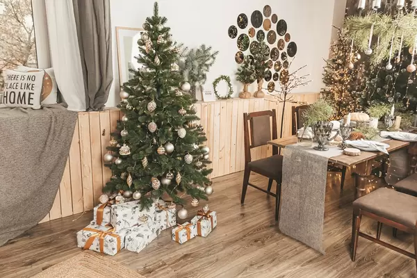 Christmas dinner with candles, table setting, decorated room with a christmas tree