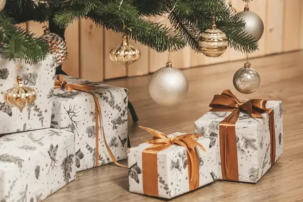 Christmas gifts and branches of a decorated christmas tree