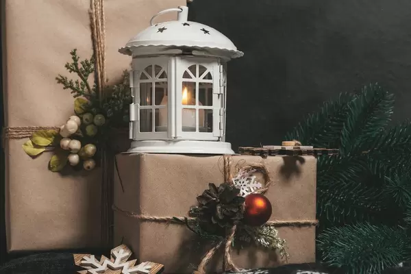 Christmas gifts with lantern and burning candles on black background (Flip 2019)