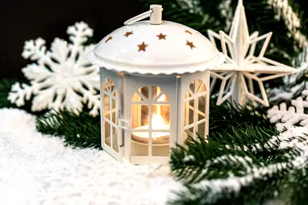 Christmas lantern glows on a winter background