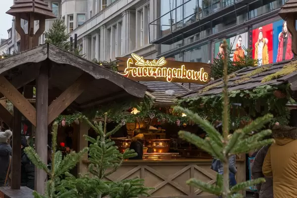 Christmas market stall sells Feuerzangenbowle, a traditional Christmas drink with hot rum
