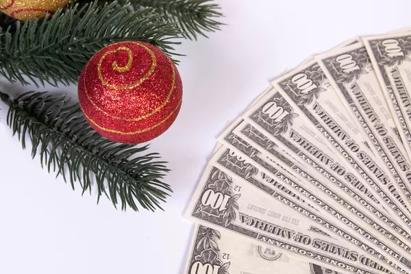 Christmas ornament and dollar banknotes on white background