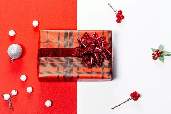 Christmas red and white background with Packed gift. Top view (Flip 2019)