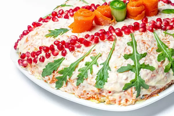 Christmas salad decorated with pomegranate seeds, arugula and vegetables (Flip 2020)
