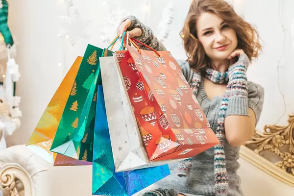 Christmas shopping, girl with many colorful gift bags