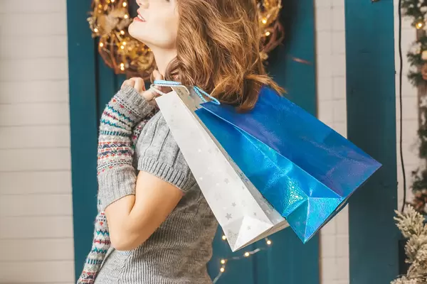 Christmas shopping, girl with packages, close-up