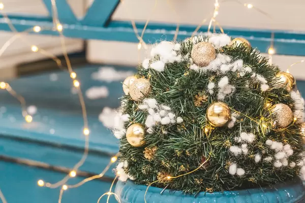 Christmas tree branches with balls, cones and garland, close-up