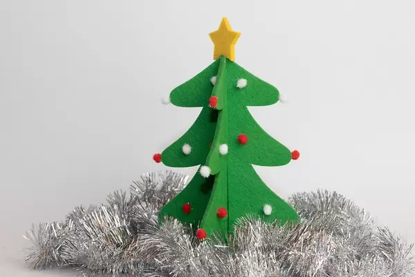 Christmas tree form felt surrounded by silver tinsel
