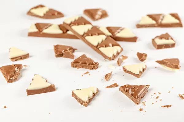 Christmas tree-shaped pieces of chocolate with white and milk chocolate