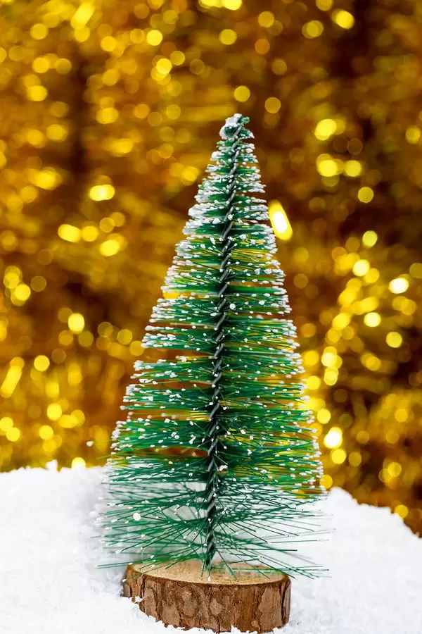 Christmas tree with snow on a Golden background