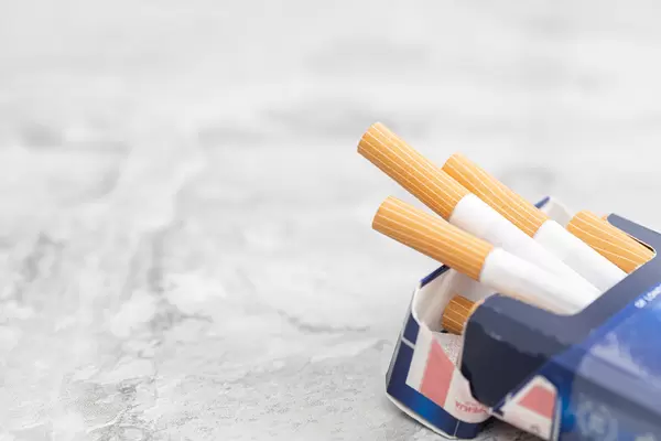 Cigarettes in the box with copy space above grey background