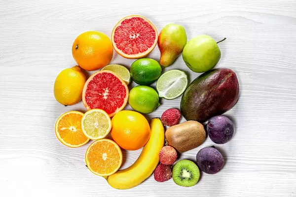 Circle of fresh fruit on white wooden background. Top view (Flip 2019)