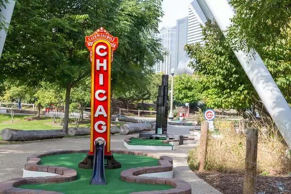 City Mini Golf in Chicago celebrating landmarks of the city, including the famous red and yellow neon sign of the Chicago Theatre and the Willis Tower
