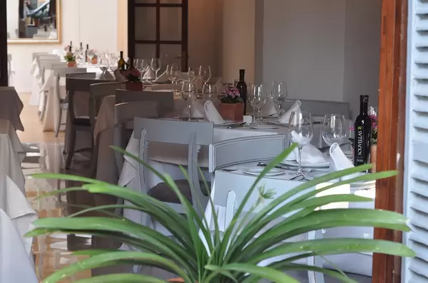 Classy restaurant with white table settings and simple chairs