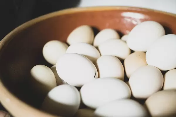 Clay bowl full of white eggs