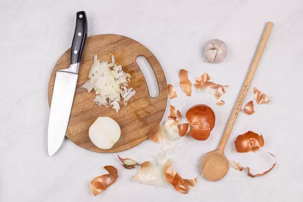 Cleaned and sliced Onions on the wooden board