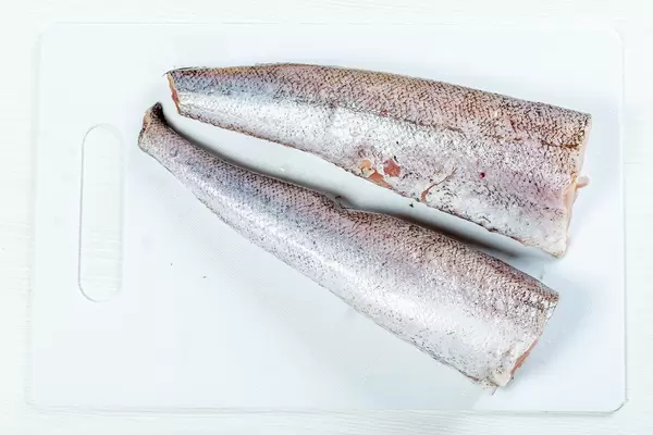 Cleaned raw fish on a white kitchen Board (Flip 2019)