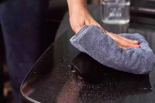 Cleaning home table with a towel
