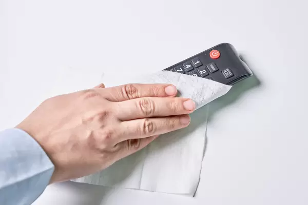 Cleaning tv remote control with wet wipe