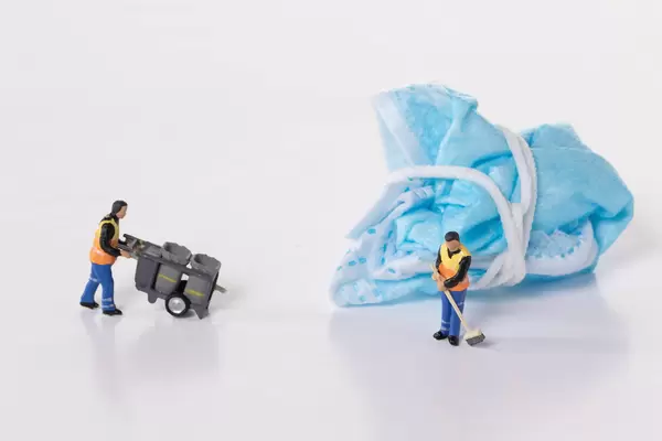 Cleaning workers and used medical face mask