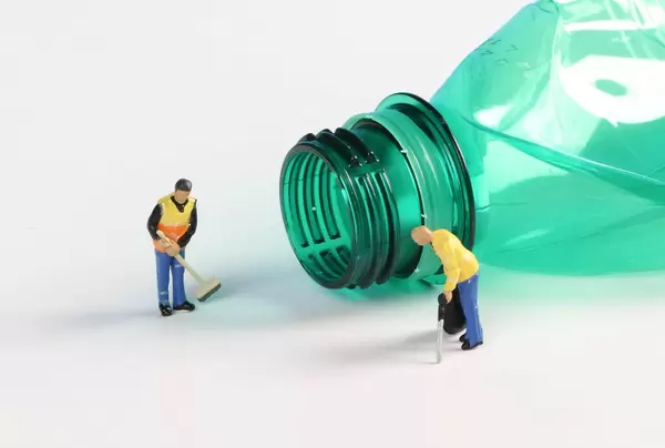 Cleaning workers with empty plastic bottle