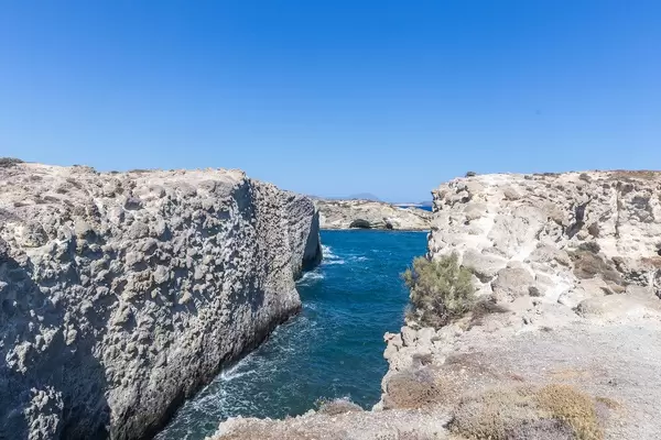 Cliffs and narrow bay of Papafrangas on the north coast of Milos, South Aegean, Greece