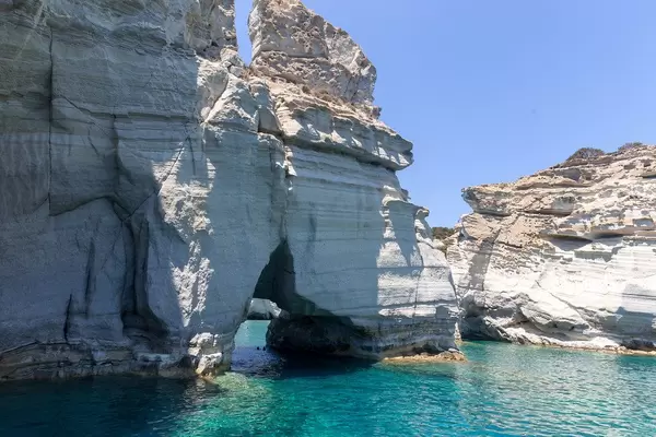 Cliffs, natural arch and crystal-clear waters in the South Aegean. The island of Milos in Greece