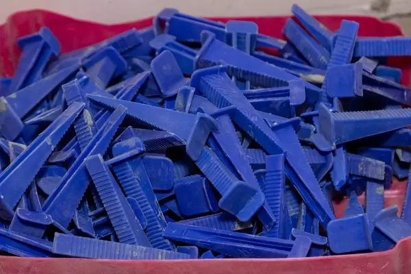 Clips that are placed between tiles in interior spaces.