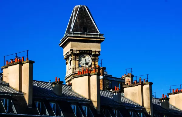 Clock on Roof of a Building in Paris