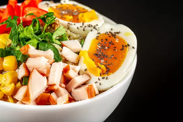 Close-up, a bowl of buckwheat porridge, meat, vegetables and a boiled egg