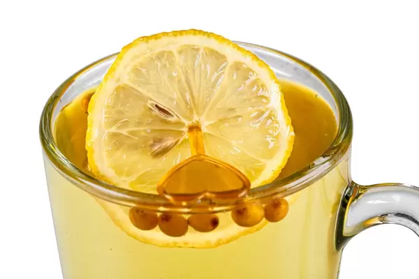 Close-up, a cup of sea buckthorn tea with a slice of lemon