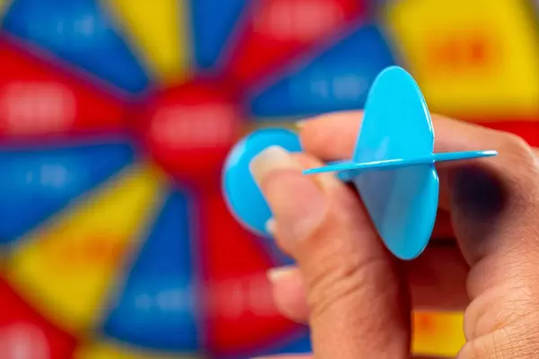 Close-up, a dartboard in a woman's hand