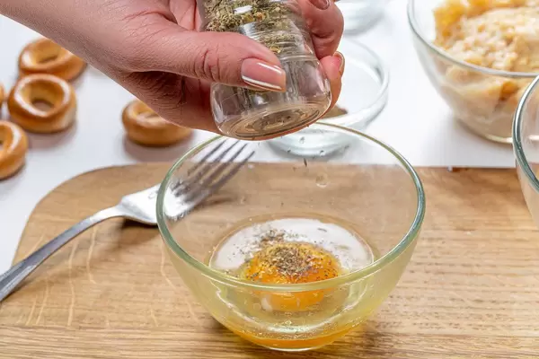 Close up adding spices to egg bowl (Flip 2019)