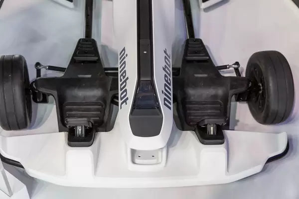 Close-up and top view of a white Gokart by ninebot, with adjustable frame and mechanical handbrake for drifting