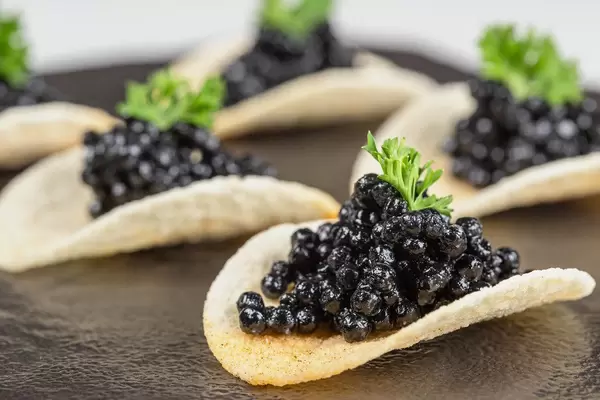Close-up, appetizer of chips with black caviar