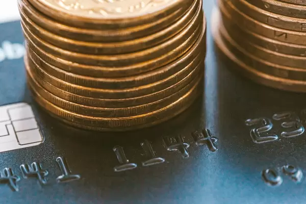 Close up, black credit card and coins
