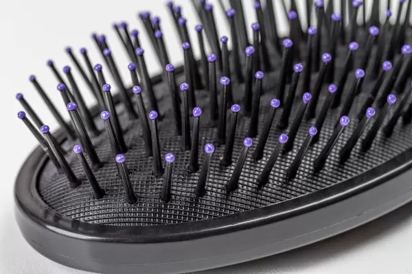 Close-up, black hairbrush on a white background (Flip 2020)
