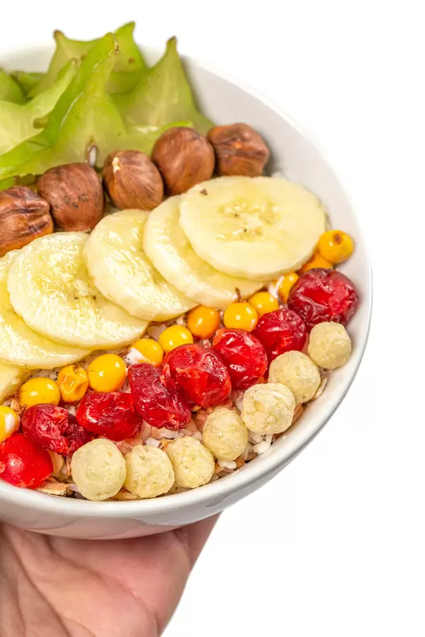 Close-up, bowl with healthy breakfast in female hand