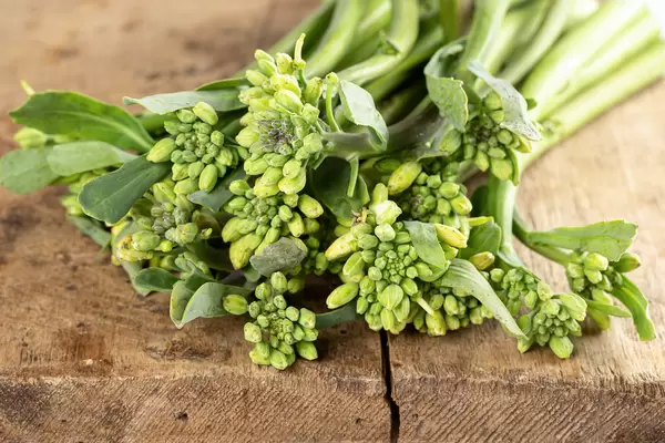 Close-up, broccolini on wooden background