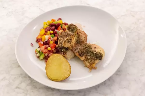 Close Up - Chicken in herb sauce, baked potato and mixed bean salad