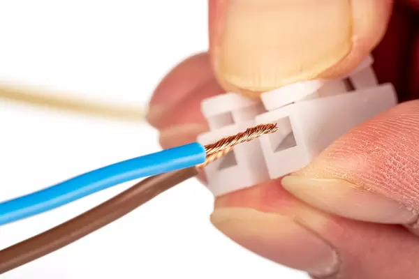 Close up, connector for electrical wiring in hand