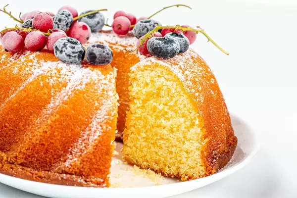 Close-up, cut vanilla muffin with berries and icing sugar