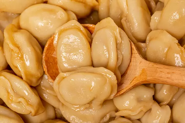 Close-up, dumplings in a wooden spoon