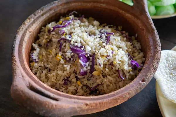 Close Up Food Photo of Fried Rice with Fish, Cabbage and Fried Egg served in a Clay Pot at a Restaurant in Saigon, Vietnam