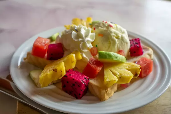 Close Up Food Photo of Plate of Fresh Fruits and Vanilla Ice Cream on a Slice of Toast