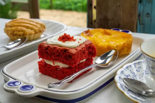 Close Up Food Photo of Red Velvet Cake with Burnt Cheesecake and Apple Pie Pastry in the Background
