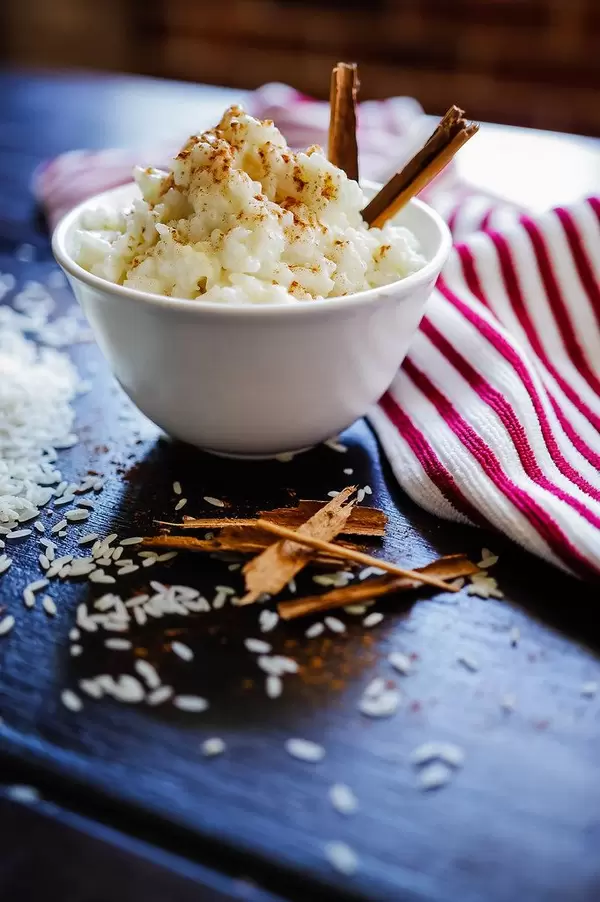 Close Up Food Photo of Rice Pudding Dessert with Cinnamon in Small Bowl